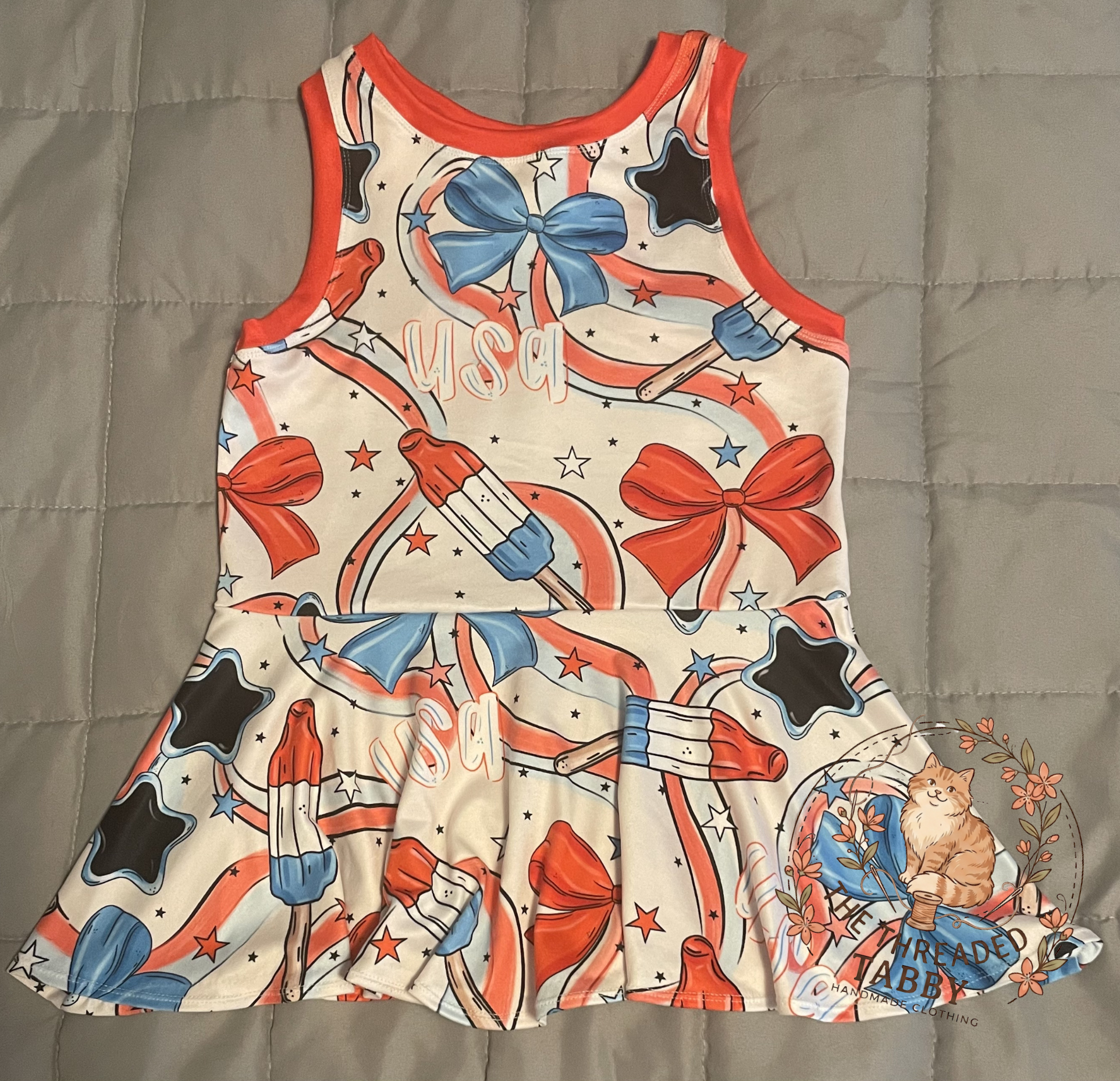 Children's dress with patriotic design featuring bows, stars, and popsicles